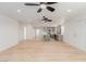Open-concept living space featuring light wood floors, ceiling fans and eat-in kitchen at 663 D Ave, Boulder City, NV 89005