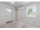 Unfinished room featuring a window, air conditioning unit, and exterior door at 663 D Ave, Boulder City, NV 89005