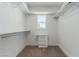 Well organized walk-in closet with ample shelving and a window at 663 D Ave, Boulder City, NV 89005