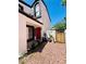 Inviting front entrance with red door, small potted plants, and desert landscaping at 6640 Crosstimber Ct, Las Vegas, NV 89108