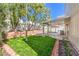 Beautiful backyard with lush green grass, mature trees, and a covered patio for relaxing and entertaining at 6649 Maple Mesa St, North Las Vegas, NV 89084