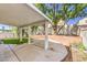 Spacious covered patio with concrete flooring, mature trees, and landscaped planters for outdoor enjoyment at 6649 Maple Mesa St, North Las Vegas, NV 89084
