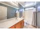 Well-lit bathroom with vanity, large mirror, and shower-tub combo at 6649 Maple Mesa St, North Las Vegas, NV 89084
