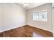 Empty bedroom with hardwood floors and bright light from one window at 6649 Maple Mesa St, North Las Vegas, NV 89084