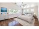 Staged bedroom with hardwood floors, a large window, and ceiling fan at 6649 Maple Mesa St, North Las Vegas, NV 89084