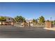 Gated community entrance with decorative brick walls and mature trees, offering security and curb appeal at 6649 Maple Mesa St, North Las Vegas, NV 89084