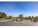 Welcoming community entrance featuring lush landscaping, mature trees, and decorative stone pillars at 6649 Maple Mesa St, North Las Vegas, NV 89084