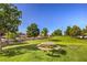Picturesque community park featuring a picnic area, mature shade trees, and well-maintained green spaces for recreation at 6649 Maple Mesa St, North Las Vegas, NV 89084
