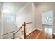 Second floor hallway with wooden floors and white walls at 6649 Maple Mesa St, North Las Vegas, NV 89084