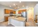 This kitchen features wood cabinets, stainless appliances, and an island with sink at 6649 Maple Mesa St, North Las Vegas, NV 89084