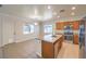 Open kitchen with stainless steel appliances, wood cabinets, and natural light at 6649 Maple Mesa St, North Las Vegas, NV 89084