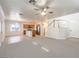 Open floor plan view from living area to kitchen with modern appliances, and a view of the stairs at 6649 Maple Mesa St, North Las Vegas, NV 89084
