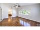 Spacious main bedroom with hardwood floors, ceiling fan, and sunlit windows at 6649 Maple Mesa St, North Las Vegas, NV 89084