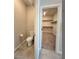 Bathroom with toilet and a view into a well-organized walk-in closet at 73 Hawk Ave, Pahrump, NV 89060