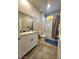 Bright bathroom featuring a granite countertop vanity and a shower-tub combination with a shower curtain at 73 Hawk Ave, Pahrump, NV 89060