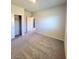 Cozy carpeted bedroom featuring a closet and a doorway leading to the hallway at 73 Hawk Ave, Pahrump, NV 89060