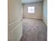 A bright bedroom with a plush carpet and a window letting in natural light at 73 Hawk Ave, Pahrump, NV 89060