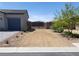 Charming single-story home featuring a low-maintenance desert landscape and gated driveway at 73 Hawk Ave, Pahrump, NV 89060