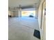 Spacious garage with concrete floor and a car parked in the driveway at 73 Hawk Ave, Pahrump, NV 89060