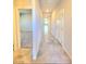 Tiled hallway providing access to a bedroom and other areas of the home at 73 Hawk Ave, Pahrump, NV 89060
