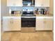 Stainless steel oven and appliances with granite countertops and white cabinets at 73 Hawk Ave, Pahrump, NV 89060