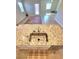 Close-up of kitchen island featuring granite countertops, stainless steel sink, and views of the living space at 73 Hawk Ave, Pahrump, NV 89060