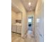 Hallway view of laundry room with appliances and bedroom with a bed at 73 Hawk Ave, Pahrump, NV 89060