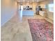 Expansive living area with a colorful rug, flowing into a modern kitchen featuring stainless steel appliances at 73 Hawk Ave, Pahrump, NV 89060