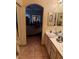 Primary bath featuring dual sinks, tile floor, and entry to bedroom with ceiling fan at 7400 W Flamingo Rd # 1090, Las Vegas, NV 89147