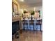 Open concept kitchen with breakfast bar seating and a view of the living area and fireplace at 7400 W Flamingo Rd # 1090, Las Vegas, NV 89147