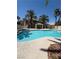 Inviting community pool with clear blue water, surrounded by lush landscaping and buildings at 7400 W Flamingo Rd # 1090, Las Vegas, NV 89147