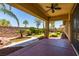 Relaxing covered patio overlooking serene pond and lush, landscaped backyard at 7434 Eggshell Dr, North Las Vegas, NV 89084