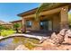 Lovely backyard with a tranquil water feature and covered patio at 7434 Eggshell Dr, North Las Vegas, NV 89084