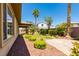 This backyard boasts a manicured lawn, mature trees, and stone landscaping at 7434 Eggshell Dr, North Las Vegas, NV 89084