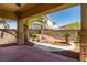Covered patio showcasing backyard's tranquil pond and lovely landscaping at 7434 Eggshell Dr, North Las Vegas, NV 89084