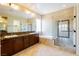 Bathroom featuring double sinks, walk-in shower, and a soaking tub for a spa-like experience at 7434 Eggshell Dr, North Las Vegas, NV 89084