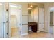 Bathroom showcasing a vanity area, walk-in shower, tile flooring, and a view into the walk-in closet at 7434 Eggshell Dr, North Las Vegas, NV 89084