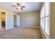 Bright bedroom with neutral tones, plush carpet, a ceiling fan, and a large window for abundant natural light at 7434 Eggshell Dr, North Las Vegas, NV 89084
