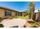 Charming home exterior with mature landscaping and a brick-paver patio at 7434 Eggshell Dr, North Las Vegas, NV 89084