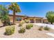 Charming single-story home featuring well-maintained desert landscaping, including a stately palm tree at 7434 Eggshell Dr, North Las Vegas, NV 89084