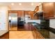 Modern kitchen with stainless steel appliances, granite countertops, and custom dark wood cabinets at 7434 Eggshell Dr, North Las Vegas, NV 89084