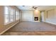 Bright living room featuring a cozy fireplace, tile and carpet flooring and white shuttered windows at 7434 Eggshell Dr, North Las Vegas, NV 89084