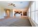 An open living area features tile and carpet floors with views of a large kitchen space at 7434 Eggshell Dr, North Las Vegas, NV 89084