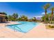 Community pool surrounded by palm trees and lounge chairs on a clear, sunny day at 7434 Eggshell Dr, North Las Vegas, NV 89084