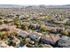 An aerial view of a neighborhood featuring desert landscaping, mountain views, and swimming pools at 7438 Desertscape Ave, Las Vegas, NV 89178