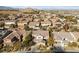 An aerial view of a neighborhood featuring beige two-story homes and beautiful mountain views in the background at 7438 Desertscape Ave, Las Vegas, NV 89178