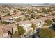 A high-angle view of tan homes with desert landscaping nestled in a cozy community with mountain views at 7438 Desertscape Ave, Las Vegas, NV 89178