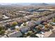 An aerial view of a desert neighborhood with beige houses, desert landscaping and mountain views at 7438 Desertscape Ave, Las Vegas, NV 89178