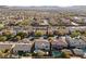 An aerial view of a neighborhood featuring desert landscaping, mountain views, and homes with swimming pools at 7438 Desertscape Ave, Las Vegas, NV 89178