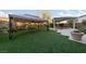 Spacious backyard with artificial turf, a gazebo, and a covered patio with spa at 7438 Desertscape Ave, Las Vegas, NV 89178
